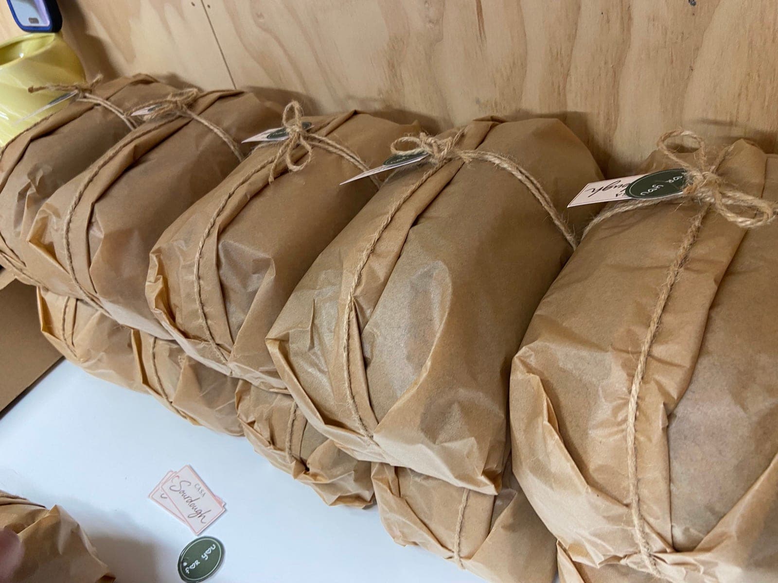 Fresh CASA loaves wrapped in paper and tied with string
