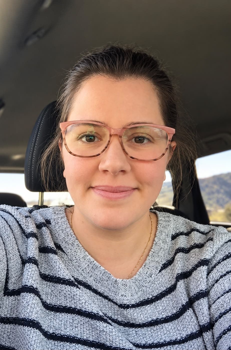 Woman wearing pink glasses smiling